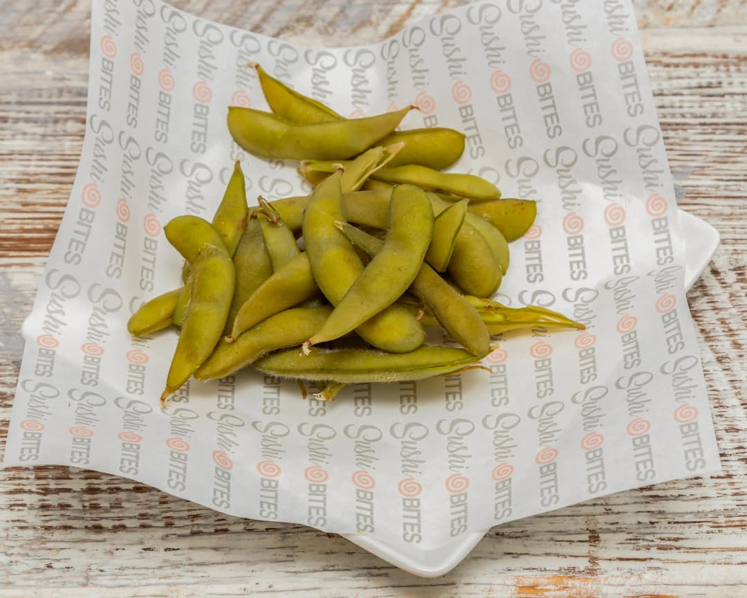 Steamed Japanese soybeans with teriyaki sauce and sesame seeds. A savory, warm side dish with a touch of salt.