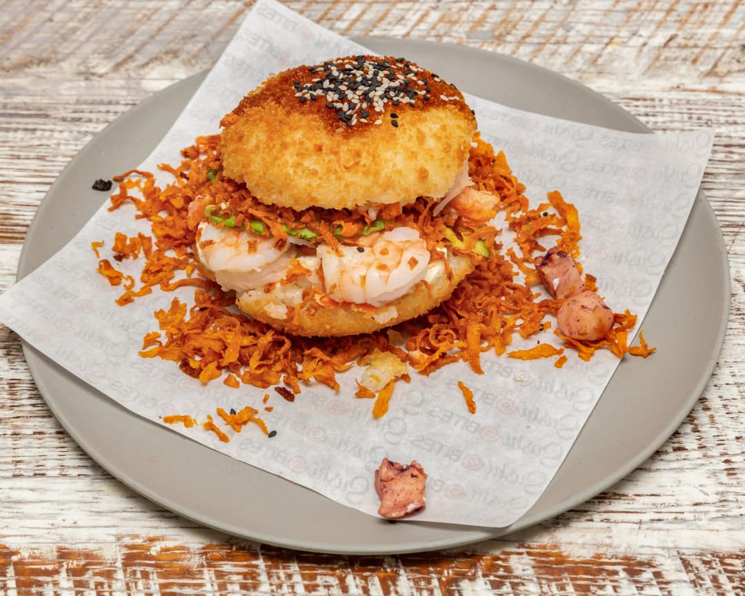 Sushi Burger with crispy rice buns, salmon, shrimp, squid, nothing raw at Tampa’s Sushi Bites.