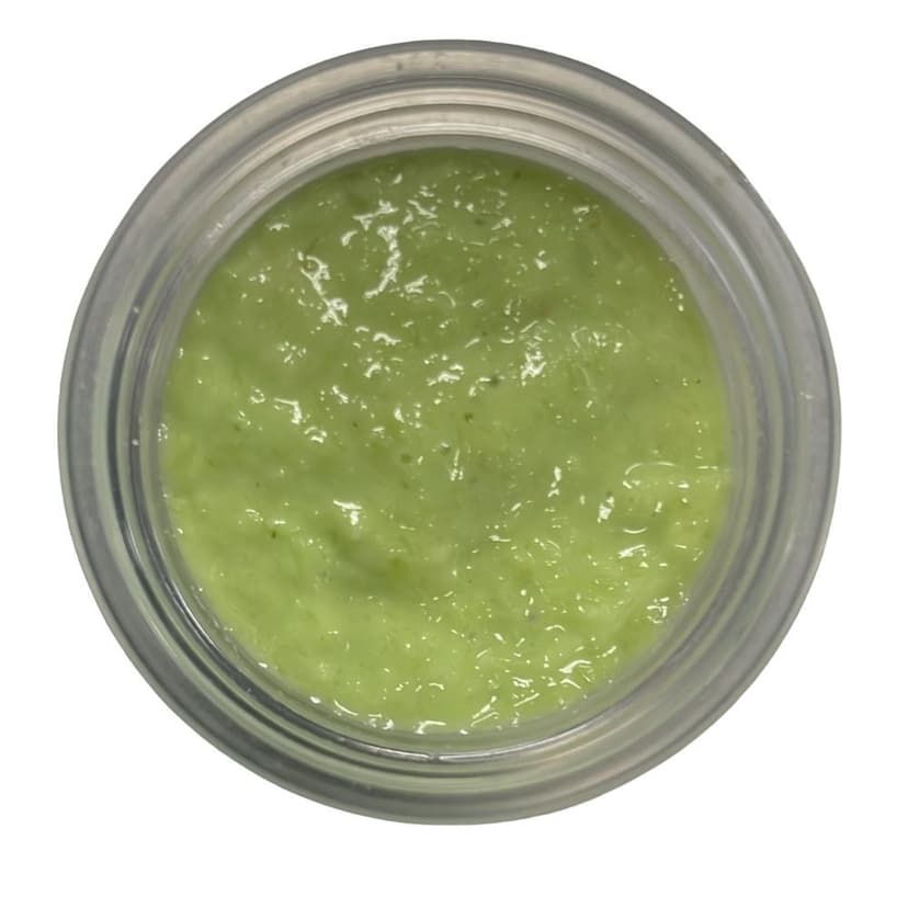A small serving of traditional Japanese wasabi paste, known for its strong, pungent flavor and heat, perfect for sushi.